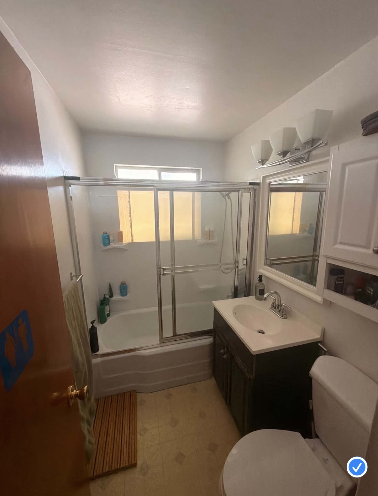 Guest bathroom before and after a sage and brass update — before